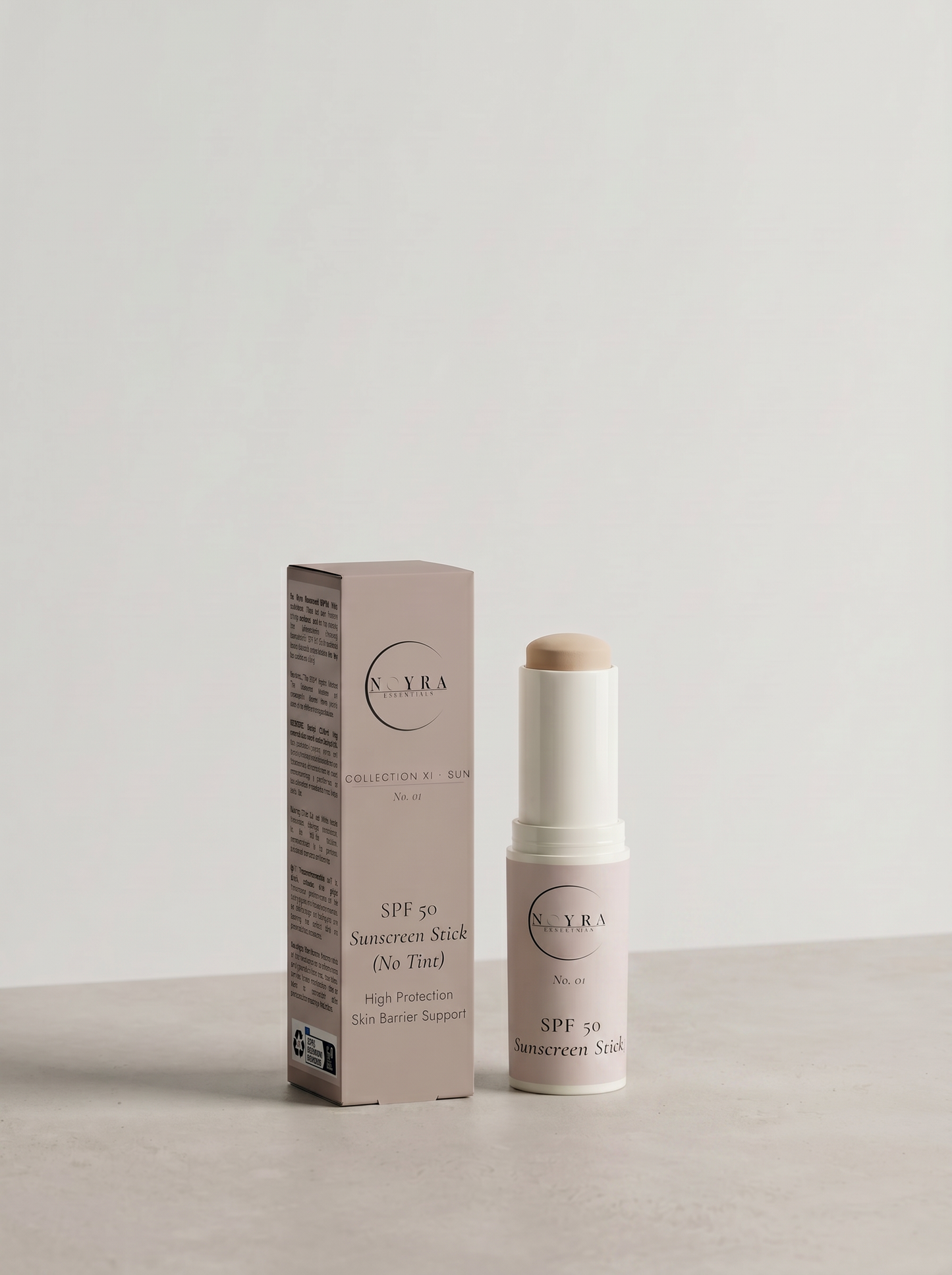 Noyra Essentials SPF50 sunscreen stick with no tint, featuring a mineral-based formula for broad-spectrum sun protection, shown with packaging on a clean neutral background